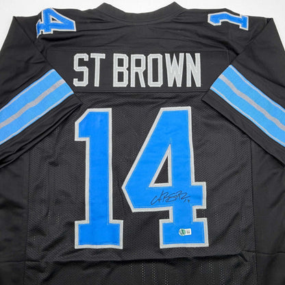 Autographed/Signed Amon-Ra St. Brown Detroit Black Football Jersey Beckett BAS COA