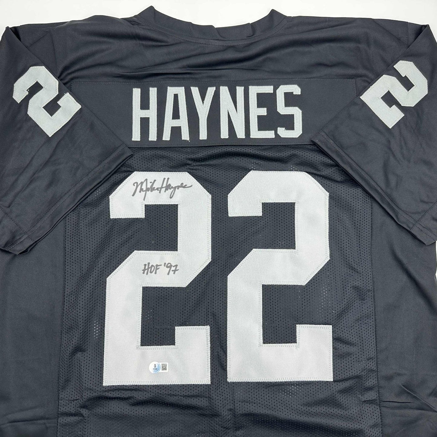 Autographed/Signed Michael Mike Haynes HOF 97 Oakland Black Football Jersey Beckett BAS COA