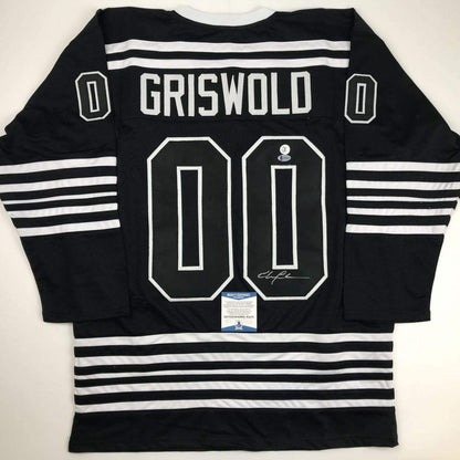 Autographed/Signed Chevy Chase Clark Griswold Christmas Vacation Movie Chicago Black Hockey Jersey Beckett BAS COA