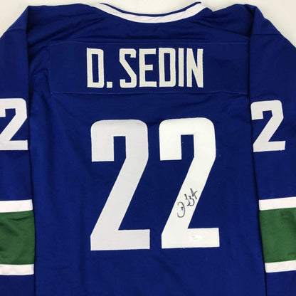Autographed/Signed Daniel Sedin Vancouver Blue Hockey Jersey JSA COA Holo Only