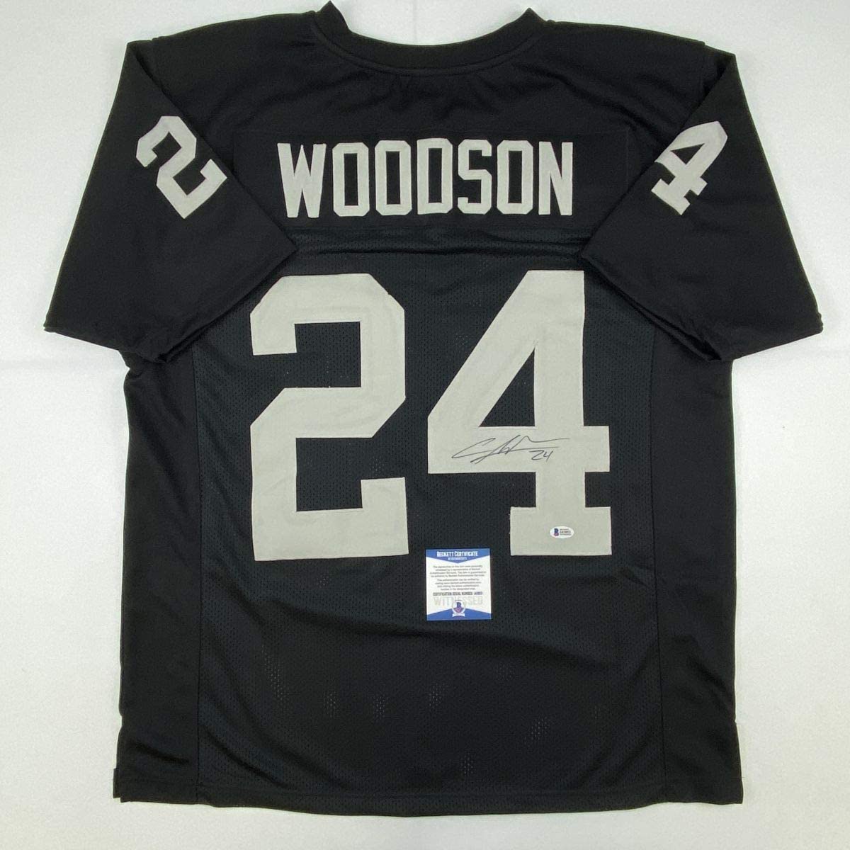 Autographed/Signed Charles Woodson Oakland Black Football Jersey Beckett BAS COA