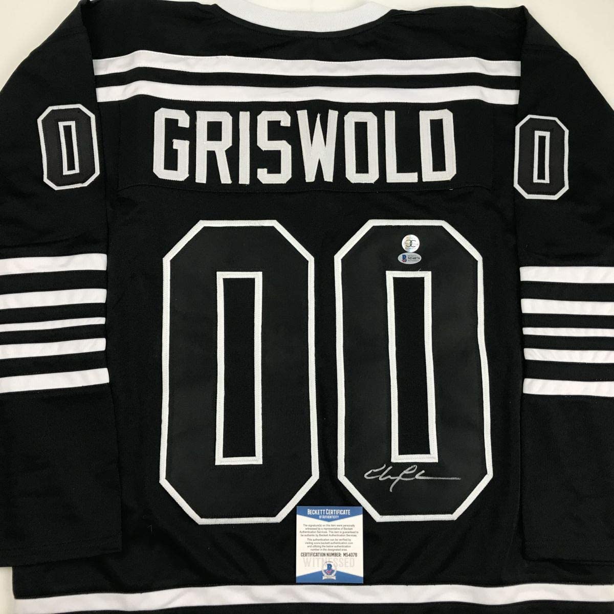 Autographed/Signed Chevy Chase Clark Griswold Christmas Vacation Movie Chicago Black Hockey Jersey Beckett BAS COA