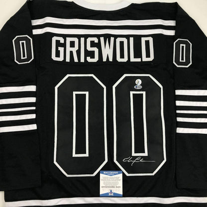 Autographed/Signed Chevy Chase Clark Griswold Christmas Vacation Movie Chicago Black Hockey Jersey Beckett BAS COA