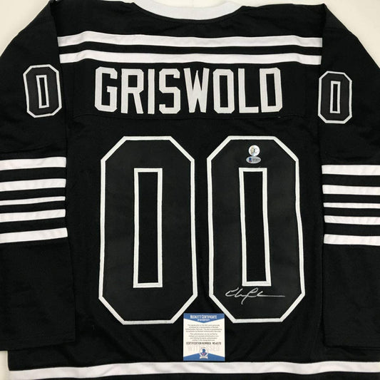 Autographed/Signed Chevy Chase Clark Griswold Christmas Vacation Movie Chicago Black Hockey Jersey Beckett BAS COA