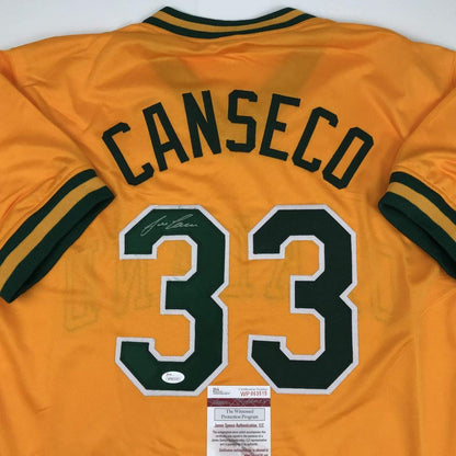 Autographed/Signed Jose Canseco Oakland Yellow Baseball Jersey JSA COA