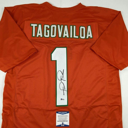 Autographed/Signed Tua Tagovailoa Miami Orange Football Jersey Beckett BAS COA