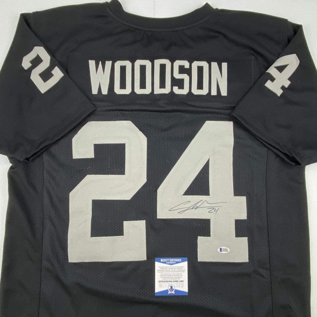 Autographed/Signed Charles Woodson Oakland Black Football Jersey Beckett BAS COA