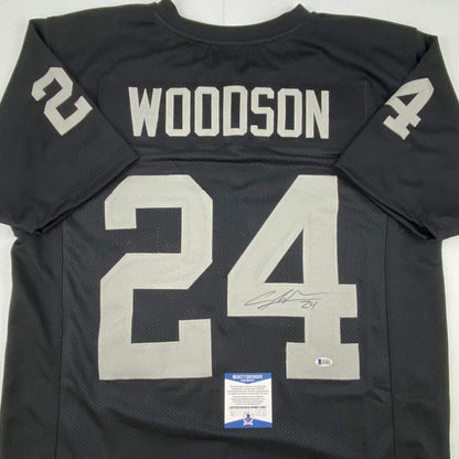 Autographed/Signed Charles Woodson Oakland Black Football Jersey Beckett BAS COA