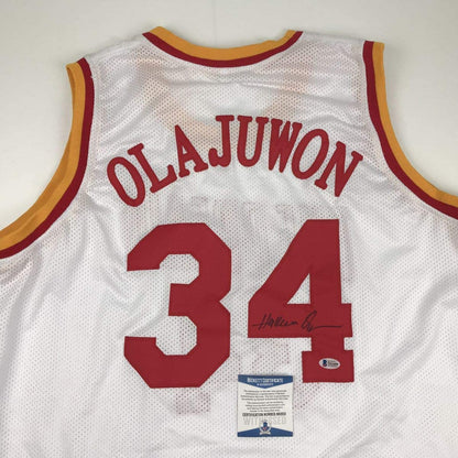 Autographed/Signed Hakeem Olajuwon Houston White Basketball Jersey Beckett BAS COA