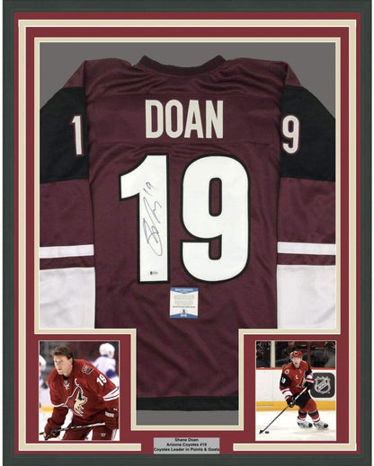 Framed Autographed/Signed Shane Doan 35x39 Arizona Maroon Hockey Jersey Beckett BAS COA