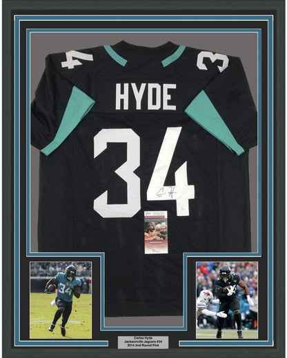 Framed Autographed/Signed Carlos Hyde 35x39 Jacksonville Black Football Jersey JSA COA