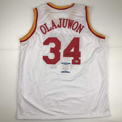 Autographed/Signed Hakeem Olajuwon Houston White Basketball Jersey Beckett BAS COA
