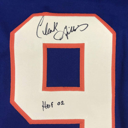 Autographed/Signed Clark Gillies HOF 02 New York Blue Hockey Jersey JSA COA