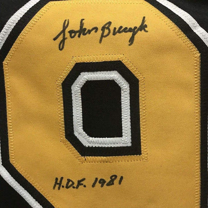 Framed Autographed/Signed John Johnny Bucyk HOF 1981 35x39 Boston Black Hockey Jersey JSA COA