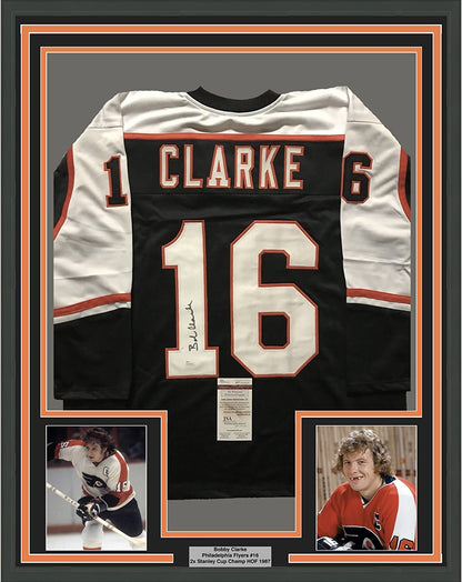 Framed Autographed/Signed Bob Bobby Clarke 35x39 Philadelphia Black Hockey Jersey JSA COA