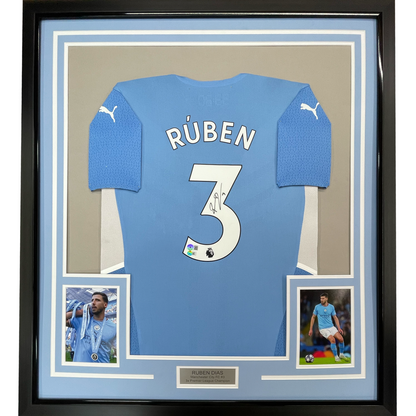 Framed Autographed/Signed Ruben Dias 35x39 Manchester City Blue Soccer Futbol Jersey Beckett BAS COA