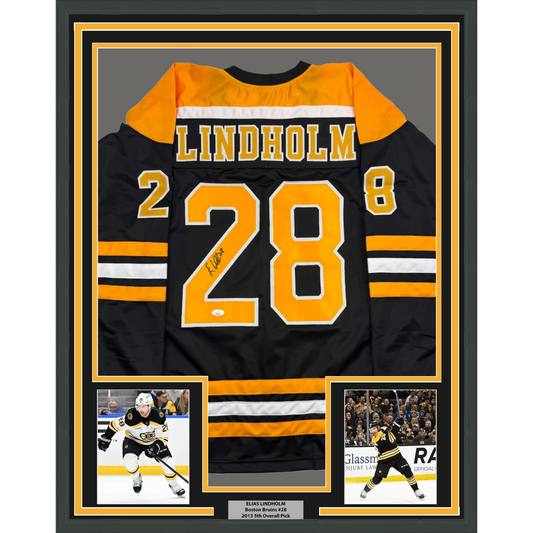 Framed Autographed/Signed Elias Lindholm 35x39 Boston Black Hockey Jersey JSA COA