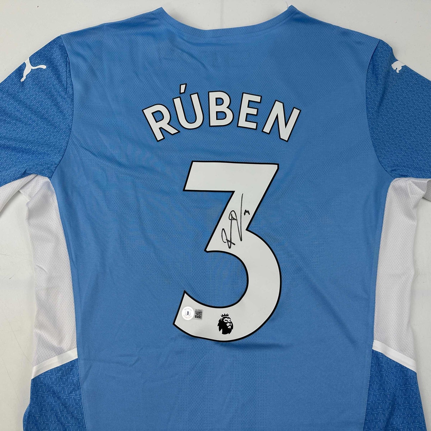 Autographed/Signed Ruben Dias Manchester City Blue Soccer Futbol Jersey Beckett BAS COA