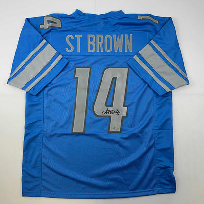 Autographed/Signed Amon-Ra St. Brown Detroit Blue Football Jersey Beckett BAS COA
