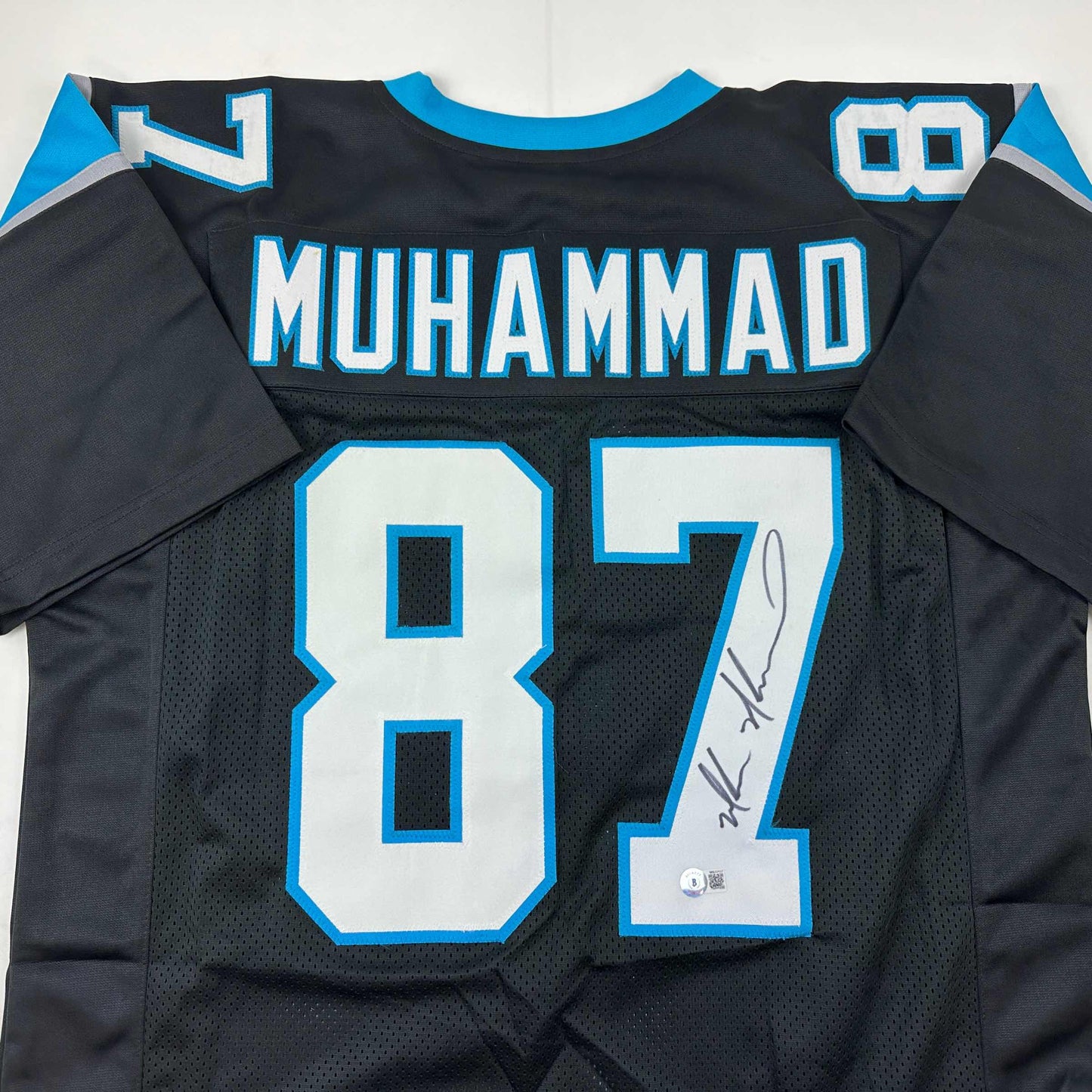 Autographed/Signed Muhsin Muhammad Carolina Black Football Jersey Beckett BAS COA