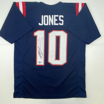 Autographed/Signed Mac Jones New England Blue Football Jersey Beckett BAS COA