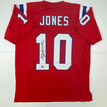 Autographed/Signed Mac Jones New England Red Football Jersey Beckett BAS COA
