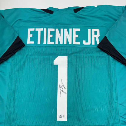 Autographed/Signed Travis Etienne Jr. Jacksonville Teal Football Jersey Beckett BAS COA