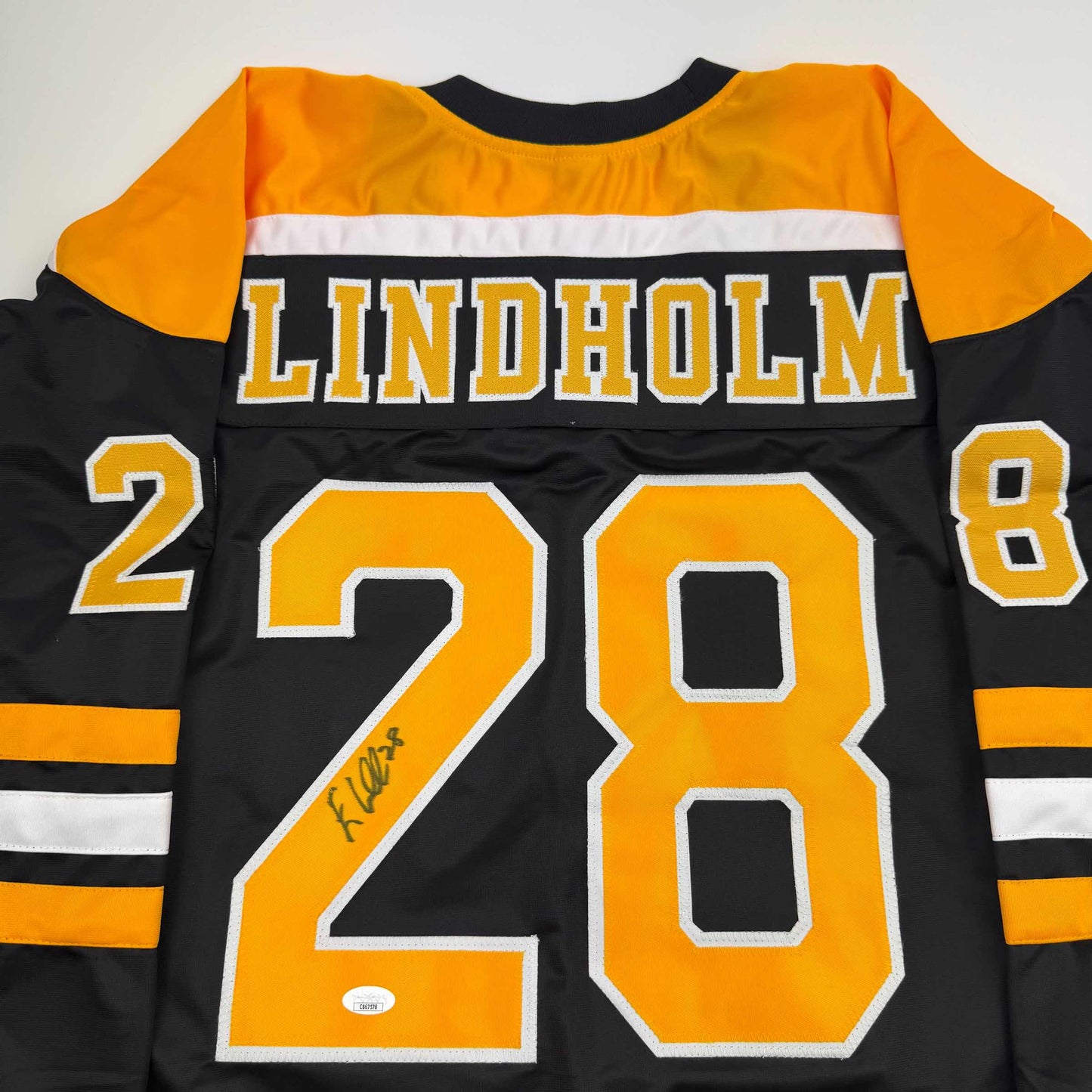 Autographed/Signed Elias Lindholm Boston Black Hockey Jersey JSA COA