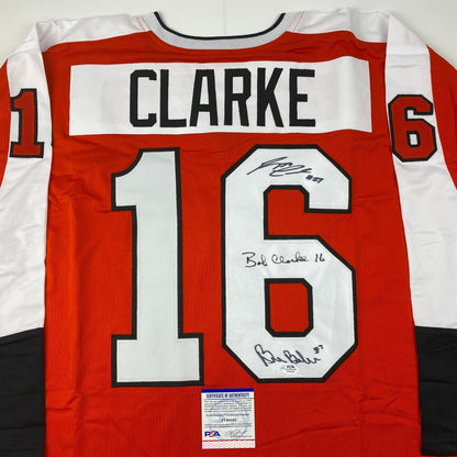 Autographed/Signed Reggie Leach, Bobby Clarke & Bill Barber Philadelphia Orange Hockey Jersey PSA/DNA COA
