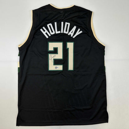 Autographed/Signed Jrue Holiday Milwaukee Black Basketball Jersey Beckett BAS COA