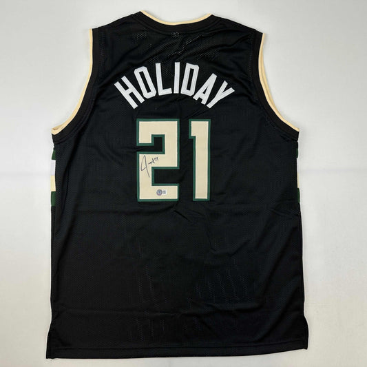 Autographed/Signed Jrue Holiday Milwaukee Black Basketball Jersey Beckett BAS COA