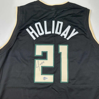 Autographed/Signed Jrue Holiday Milwaukee Black Basketball Jersey Beckett BAS COA