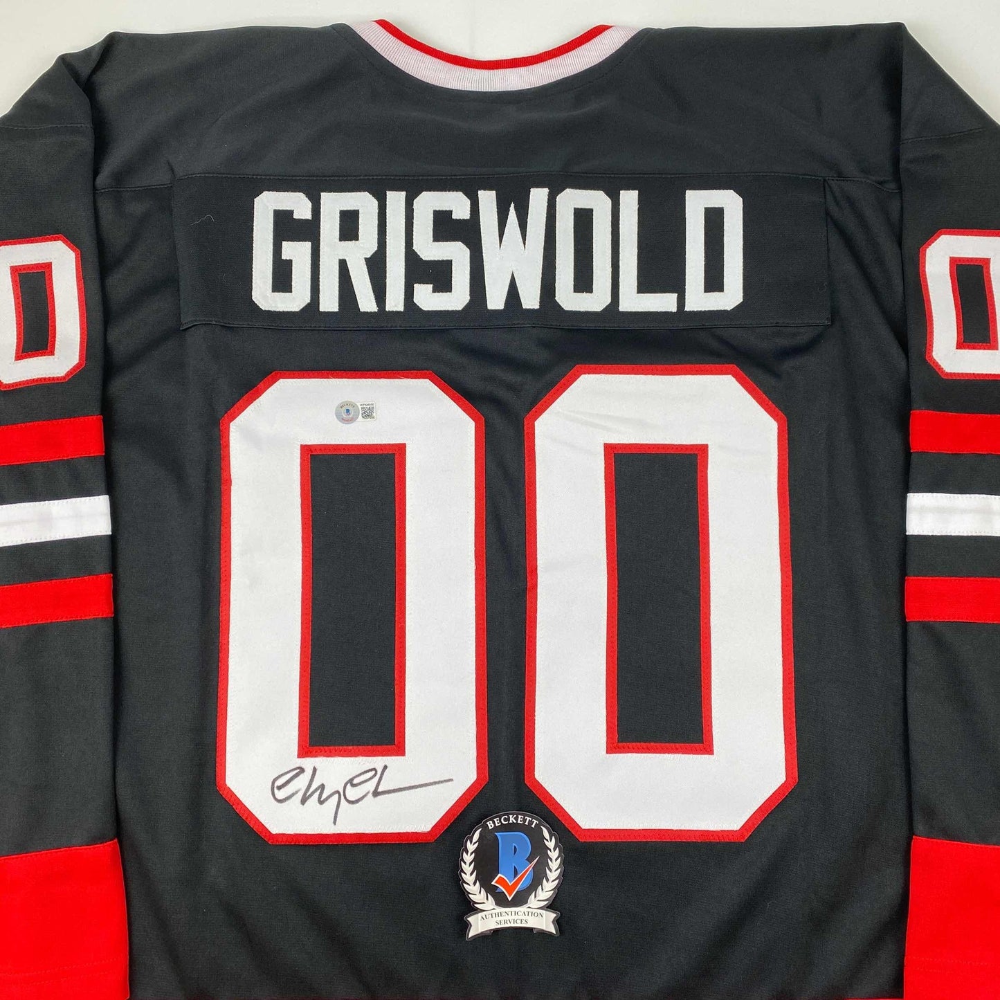 Autographed/Signed Chevy Chase Clark Griswold Christmas Vacation Movie Chicago Black Hockey Jersey Beckett BAS COA