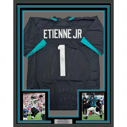 Framed Autographed/Signed Travis Etienne Jr. 35x39 Jacksonville Black Football Jersey Beckett BAS COA
